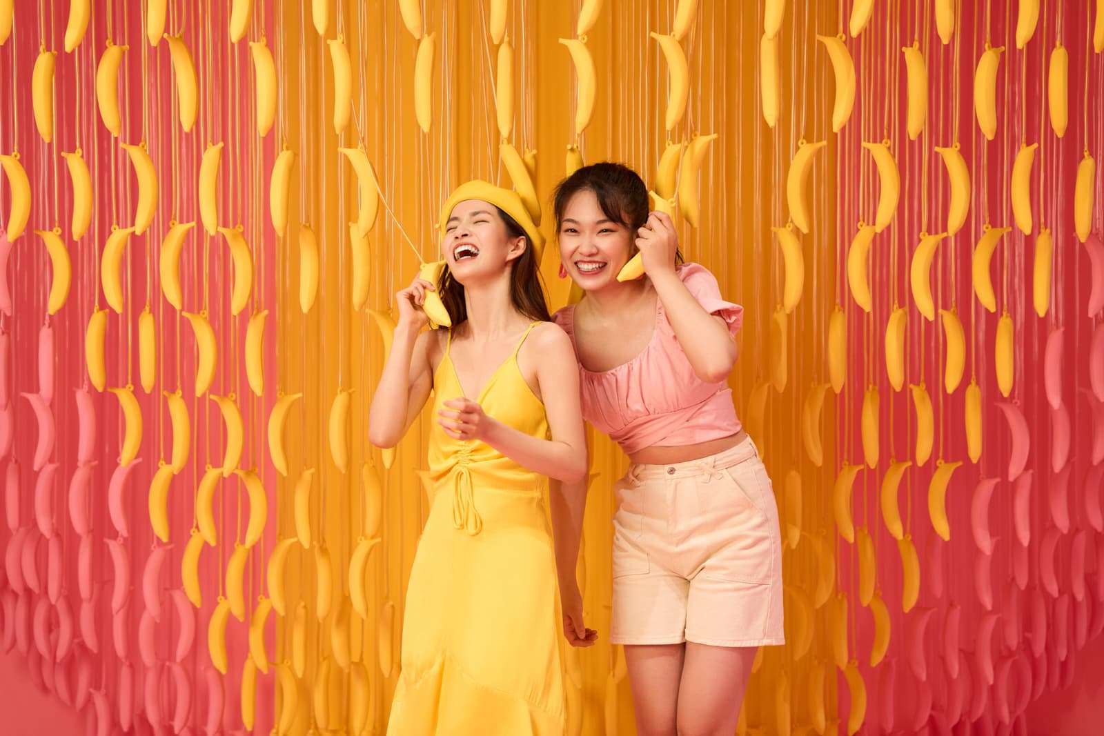 Lifestyle brand campaign with two women laughing at colorful pop-up installation in Shanghai by Una Zhu