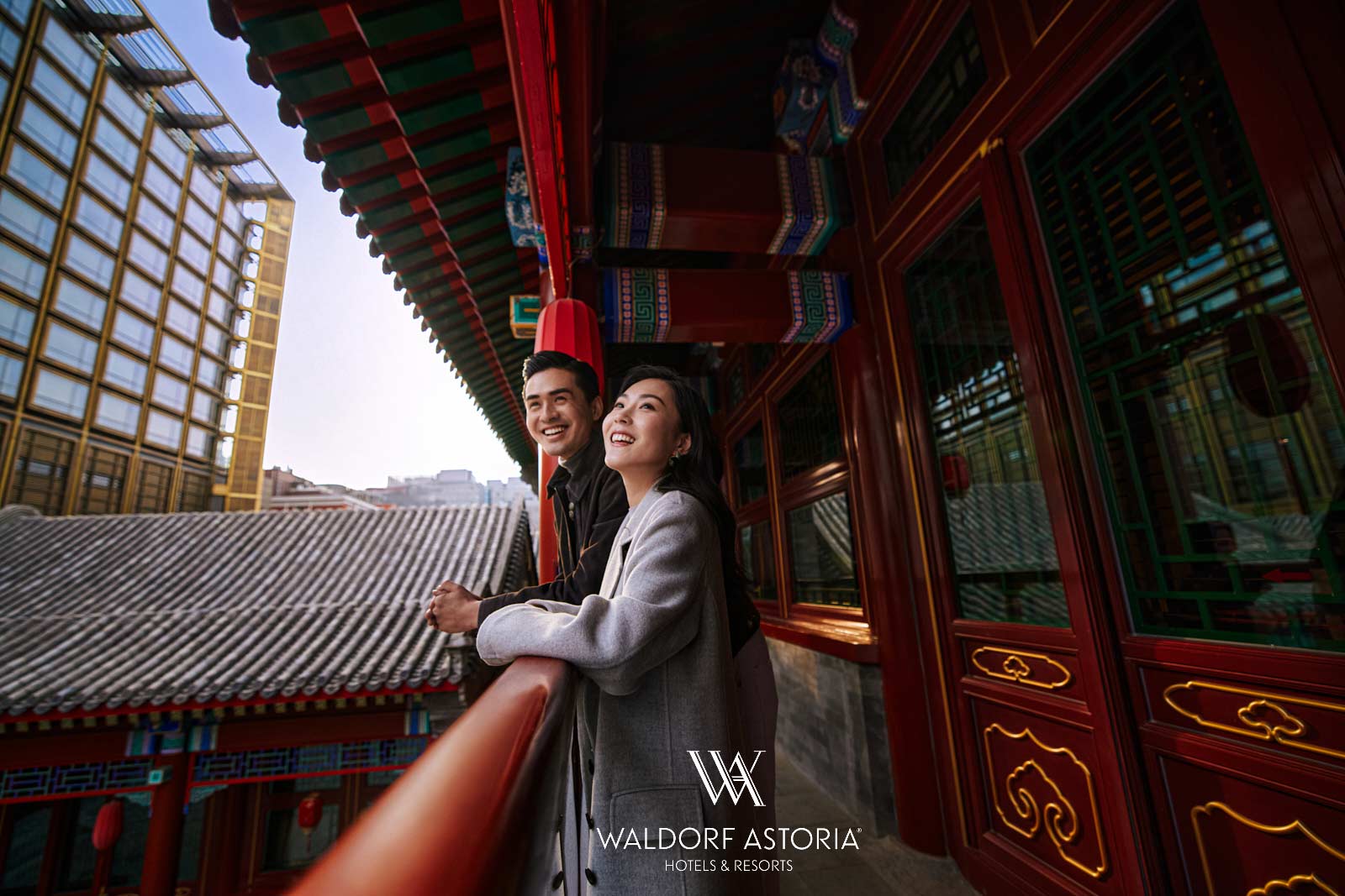 Waldorf Astoria hotel lifestyle campaign with couple on balcony overlooking traditional Beijing rooftops by Una Zhu