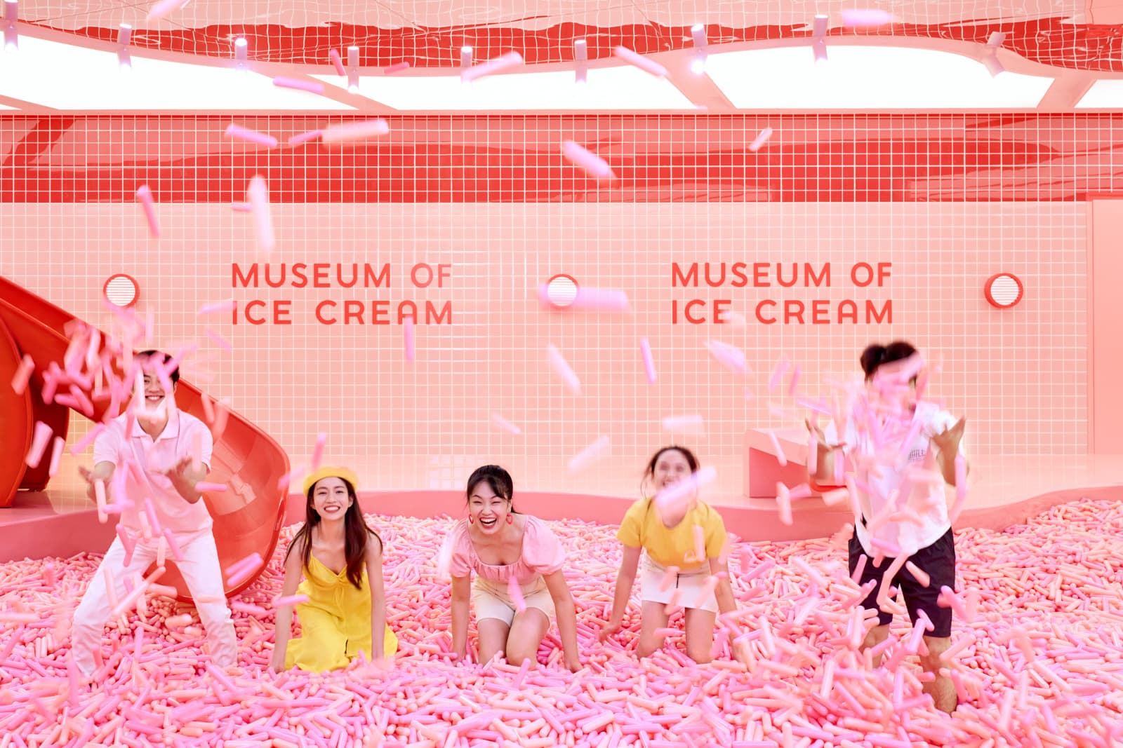Museum of Ice Cream brand activation with group playing in pink sprinkle pool in Shanghai by Una Zhu