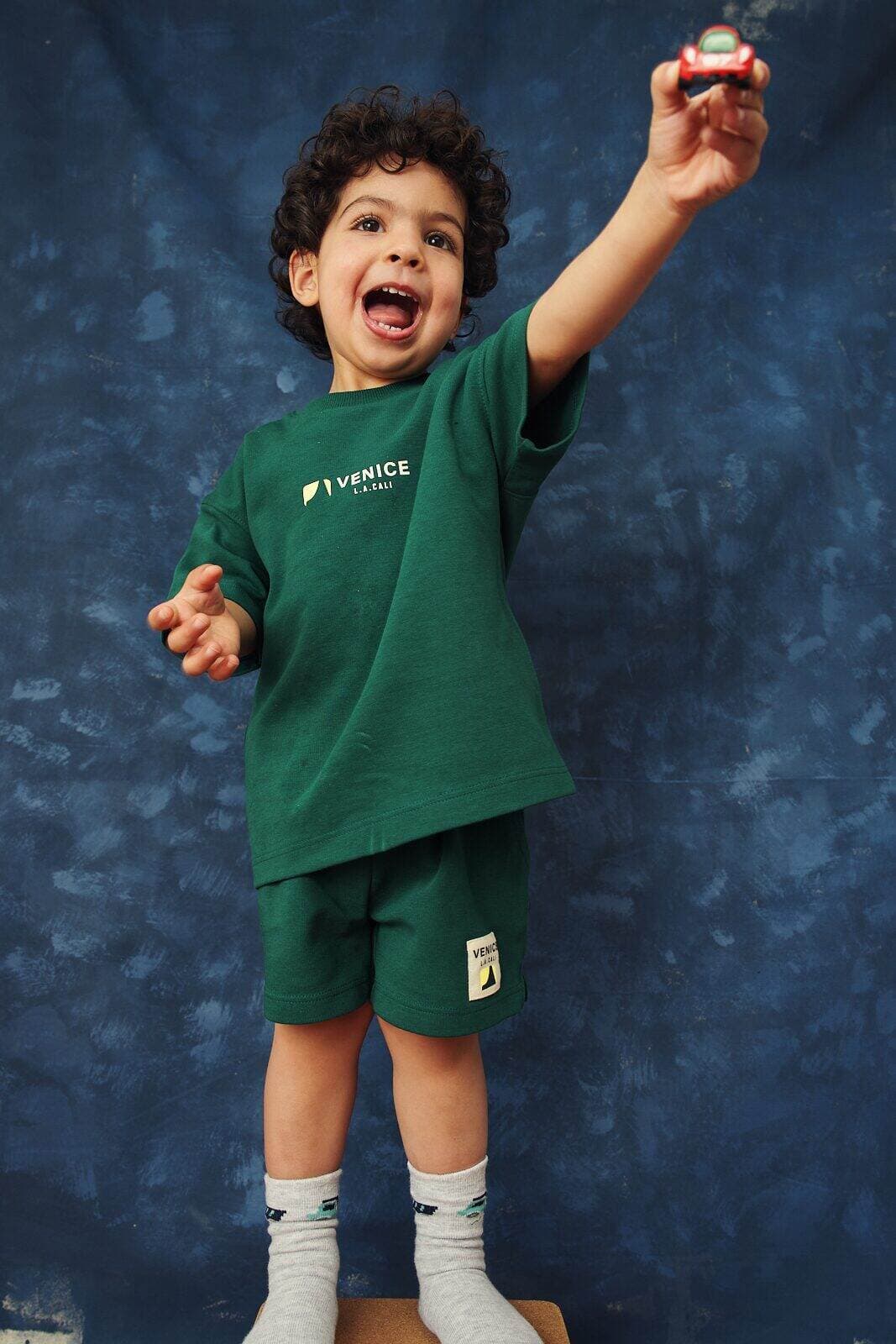 Natural photo of a preschooler mid movement with one arm raised during an unposed session by Una Zhu