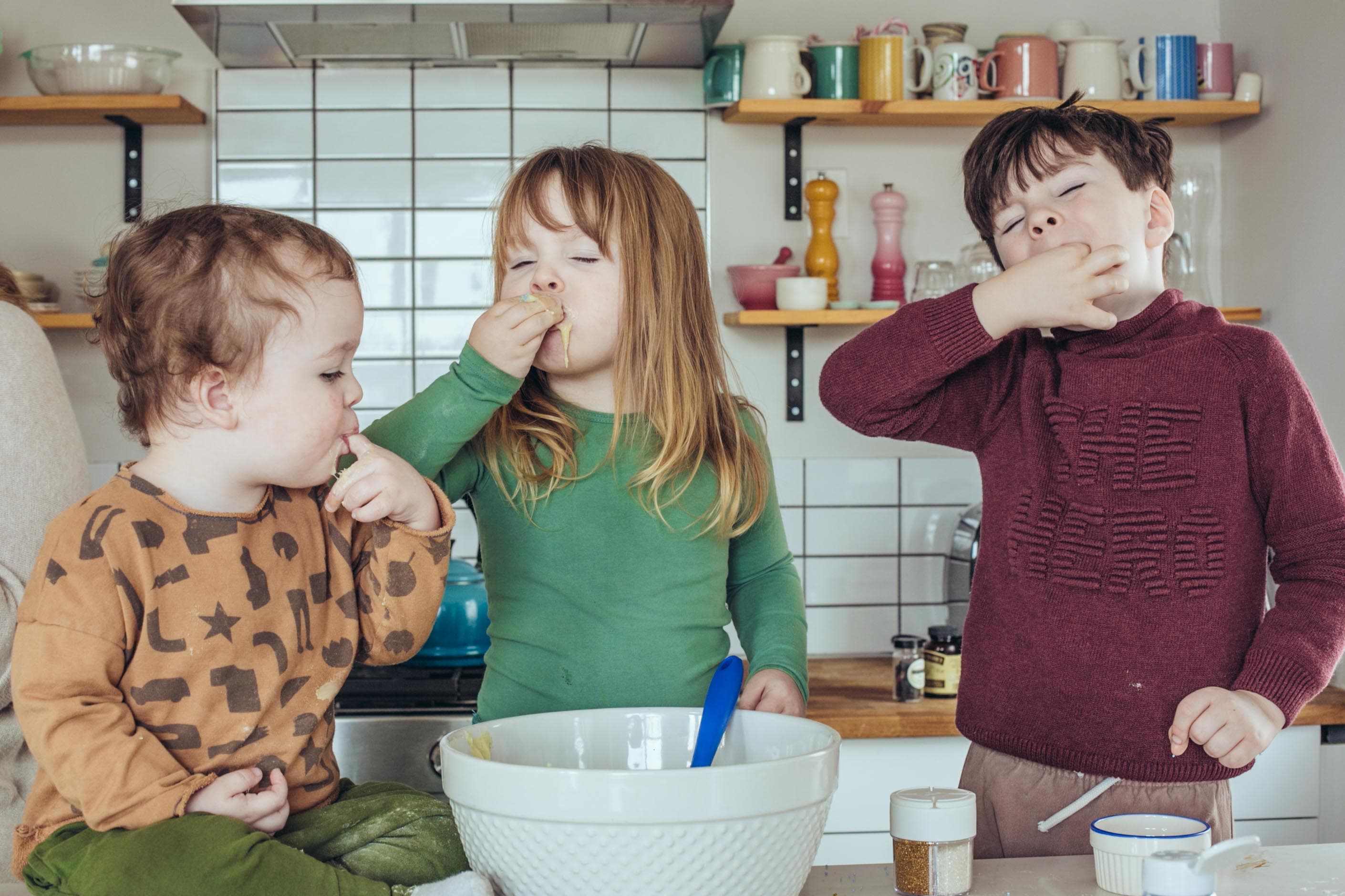 Lifestyle kids commercial photography of children baking together in natural light kitchen by Una Zhu