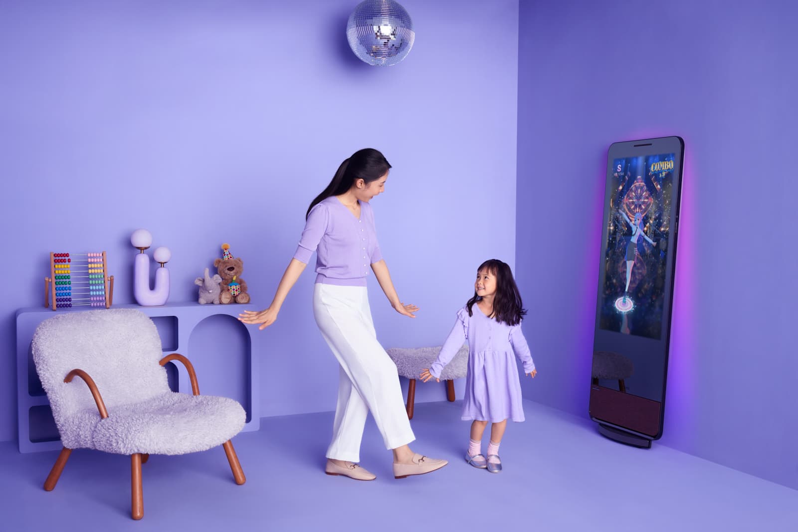 Lifestyle children advertising with toddler girl dancing in lavender room set by Una Zhu