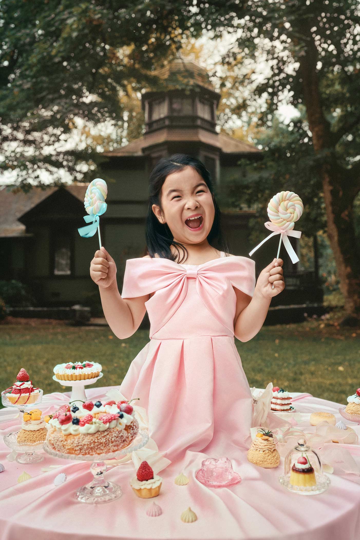 Editorial kids fashion photography with child in pink bow dress for apparel lookbook by Una Zhu